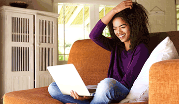 Woman-on-Couch-with-Laptop.png